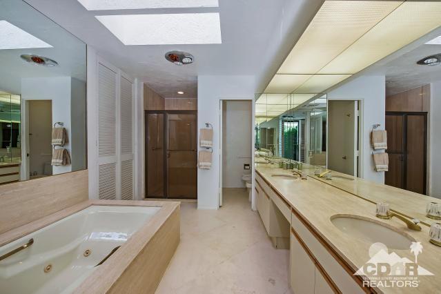 6 Exeter Court Rancho Mirage, CA 92270 - Photo 12 of 20 a bathroom with a granite countertop tub sink and mirror
