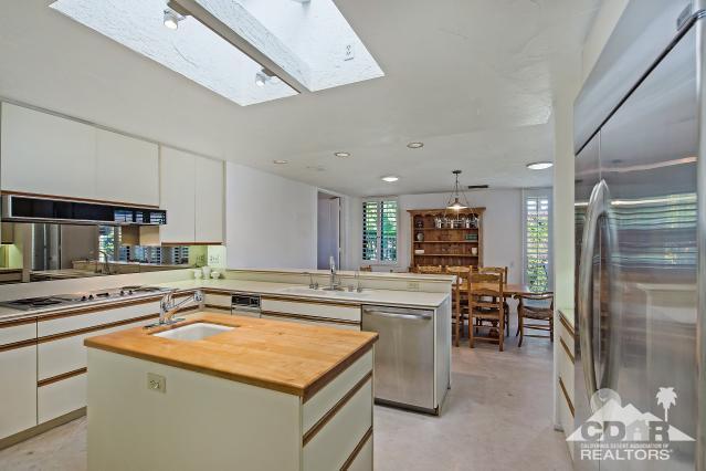 6 Exeter Court Rancho Mirage, CA 92270 - Photo 6 of 20 a kitchen with kitchen island a sink stove and refrigerator