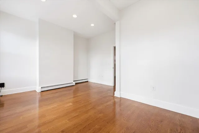 an empty room with wooden floor