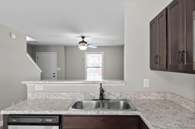 a kitchen with a sink and a refrigerator