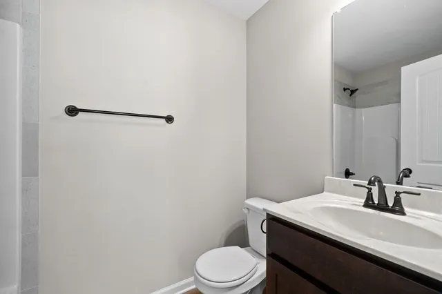 a bathroom with a sink a toilet and mirror