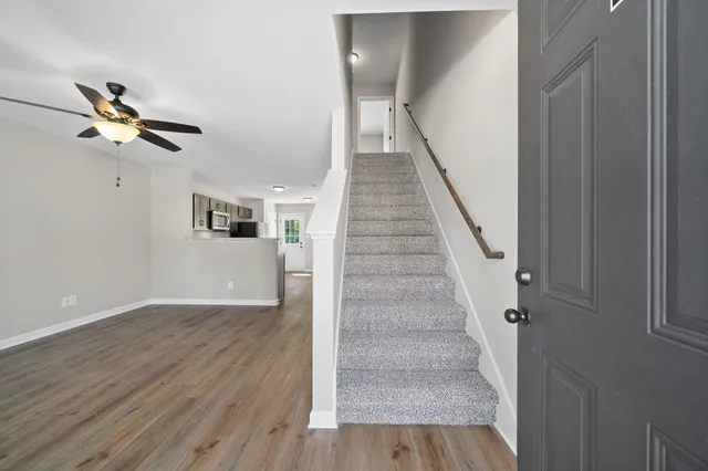 a view of entryway and hall with wooden floor