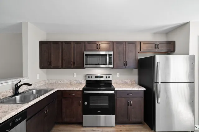 a kitchen with a refrigerator and a sink