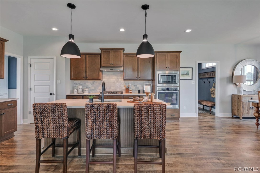 11831 Winterpock Road Chesterfield, VA 23838 - Photo 13 of 34 a kitchen with stainless steel appliances a dining table chairs and white cabinets