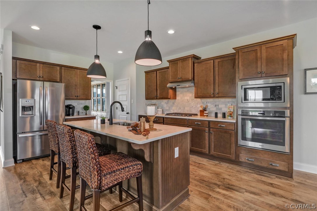 11831 Winterpock Road Chesterfield, VA 23838 - Photo 14 of 34 a kitchen with stainless steel appliances granite countertop a sink a stove a refrigerator cabinets and a kitchen island