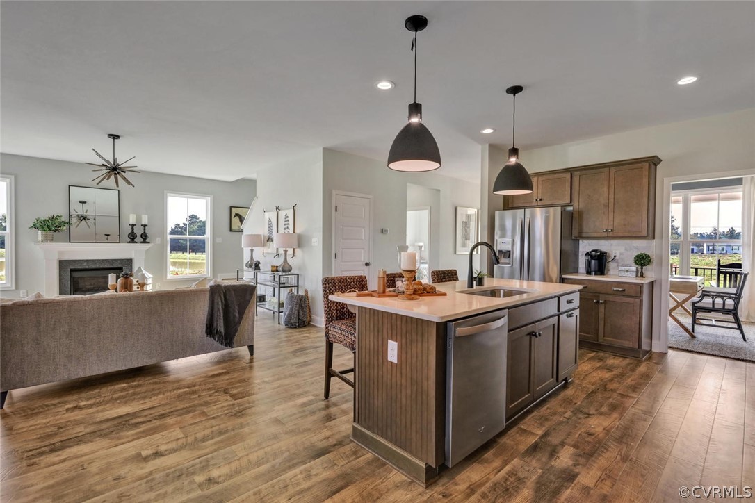 11831 Winterpock Road Chesterfield, VA 23838 - Photo 16 of 34 a kitchen with kitchen island a stove a sink a center island and wooden floor
