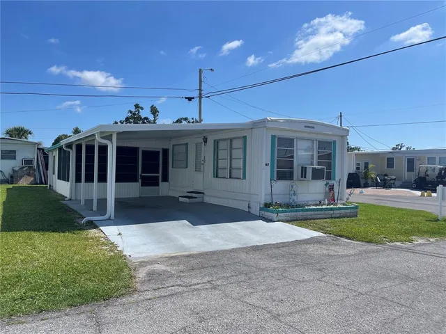 a front view of a house with a garden and yard