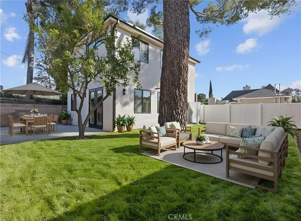 a view of a patio with couches chairs and a big yard