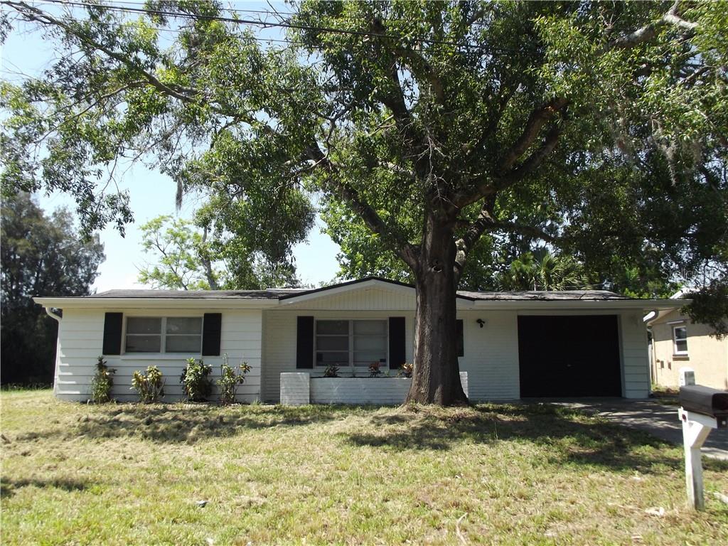 6331 Gainsboro Drive Port Richey, FL 34668 - Photo 1 of 1 a view of a house with a tree in front of it