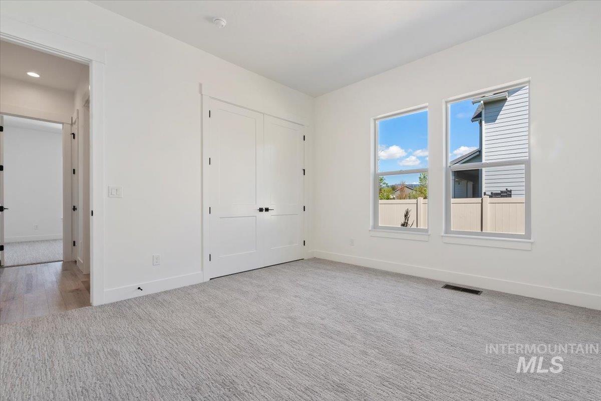 2391 East Snocreek Drive Eagle, ID 83616 - Photo 17 of 29 Unfurnished bedroom with light carpet and a closet