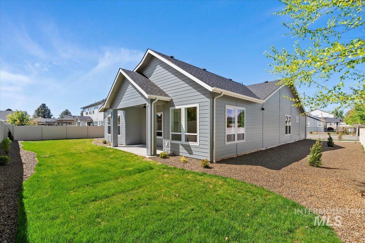 2391 East Snocreek Drive Eagle, ID 83616 - Photo 26 of 29 Back of house with a fenced backyard, a patio area, and a shingled roof