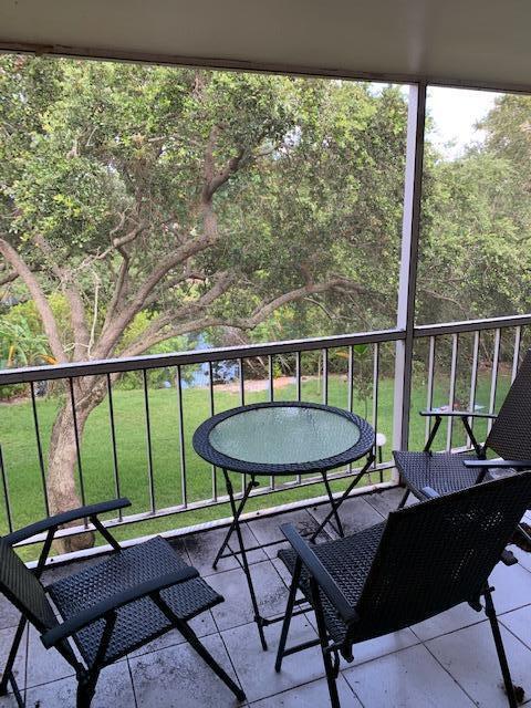 644 Northwest 13th Street, Unit 35 Boca Raton, FL 33486 - Photo 2 of 5 a view of a chairs and table in patio