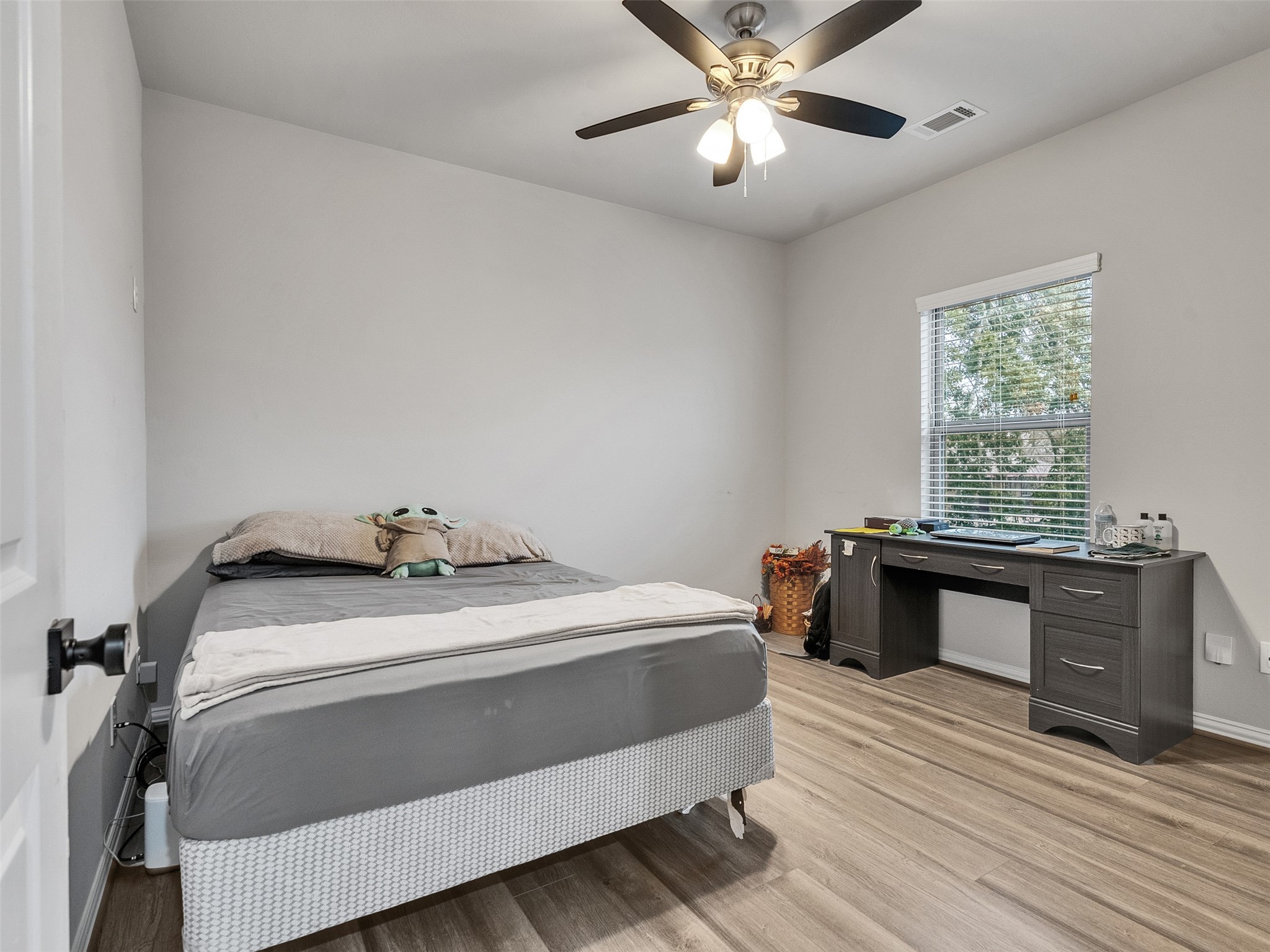 2411 Charles Road, Unit A Houston, TX 77093 - Photo 16 of 33 a bedroom with a bed and a chandelier