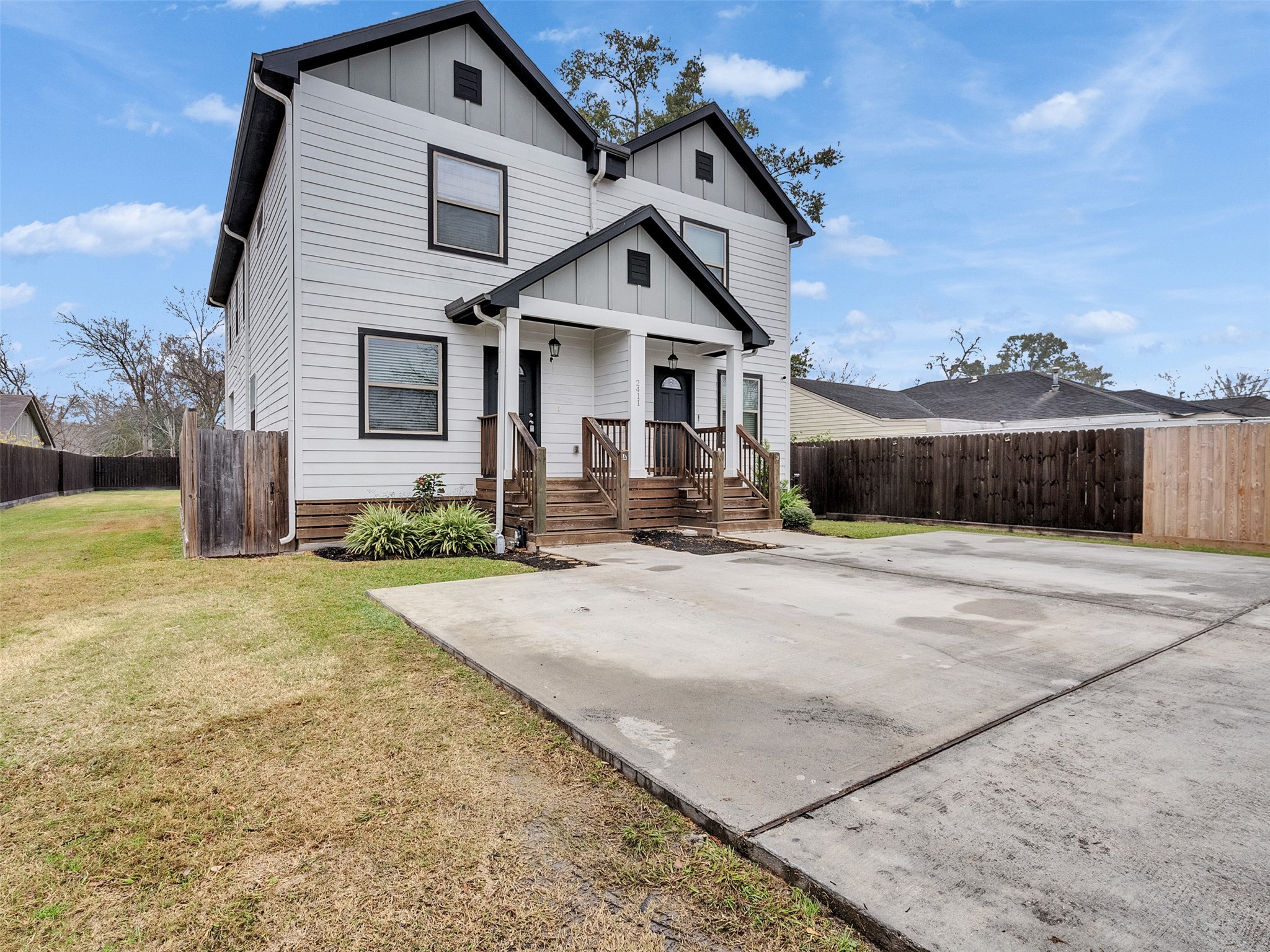 2411 Charles Road, Unit A Houston, TX 77093 - Photo 26 of 33 a front view of a house with a yard and garage