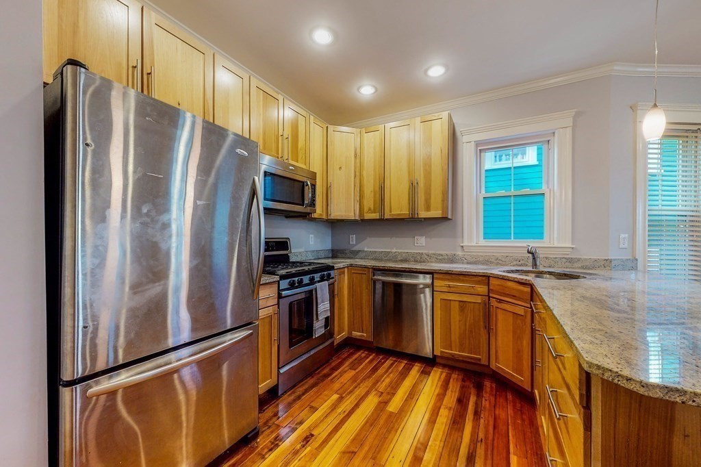 77 Montebello Road, Unit 2 Boston, MA 02130 - Photo 8 of 24 a kitchen with granite countertop stainless steel appliances a sink and counter space