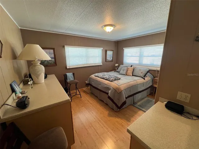 a bedroom with a bed and large mirror