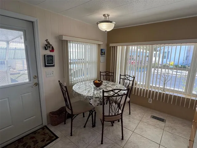a view of a dining room with furniture window and outside view