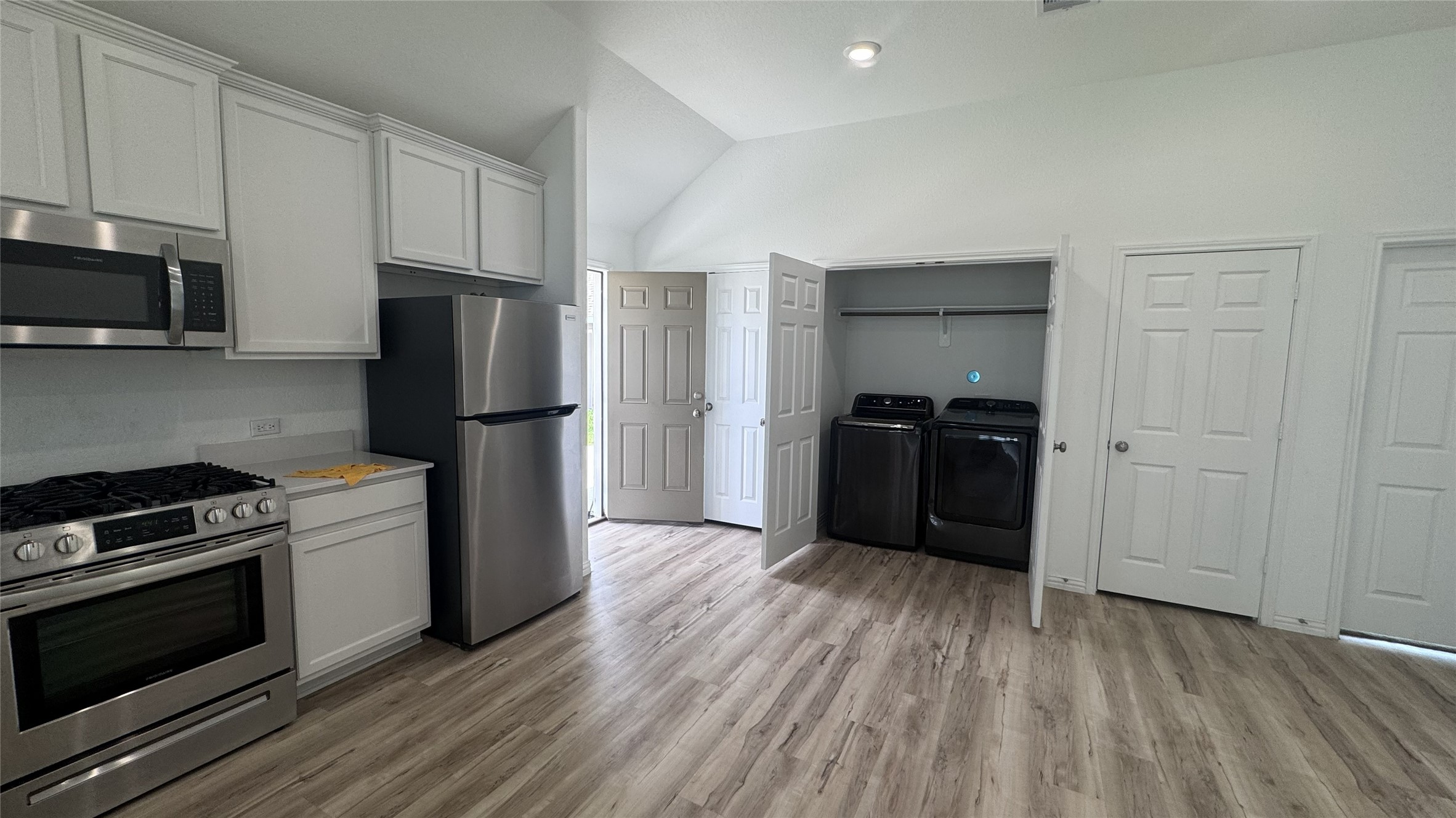 15746 Harding Bend Drive Humble, TX 77346 - Photo 5 of 18 a kitchen with a refrigerator stove and wooden cabinets