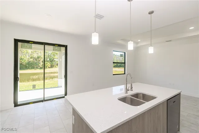 a kitchen with a sink a counter top space and a wooden floor