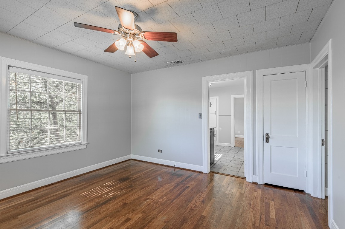1415 22nd Street Huntsville, TX 77340 - Photo 14 of 30 a view of an empty room with wooden floor and a window