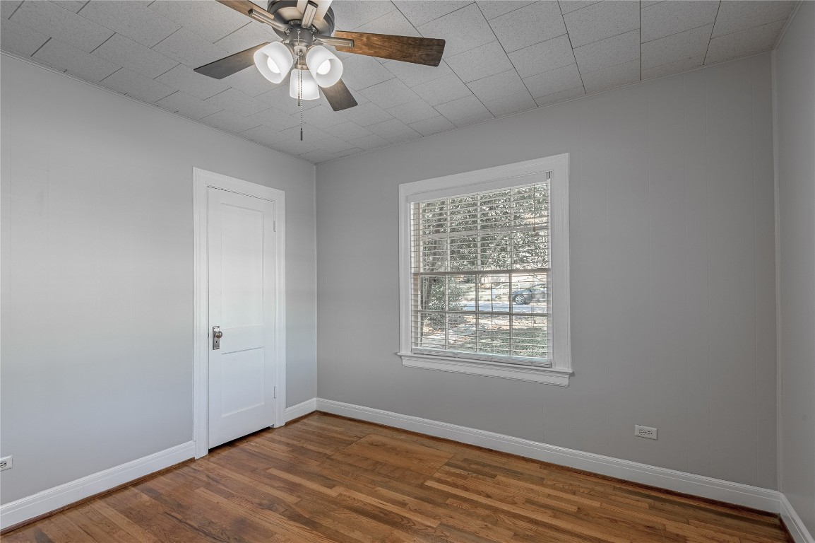 1415 22nd Street Huntsville, TX 77340 - Photo 20 of 30 a view of an empty room with wooden floor and a window