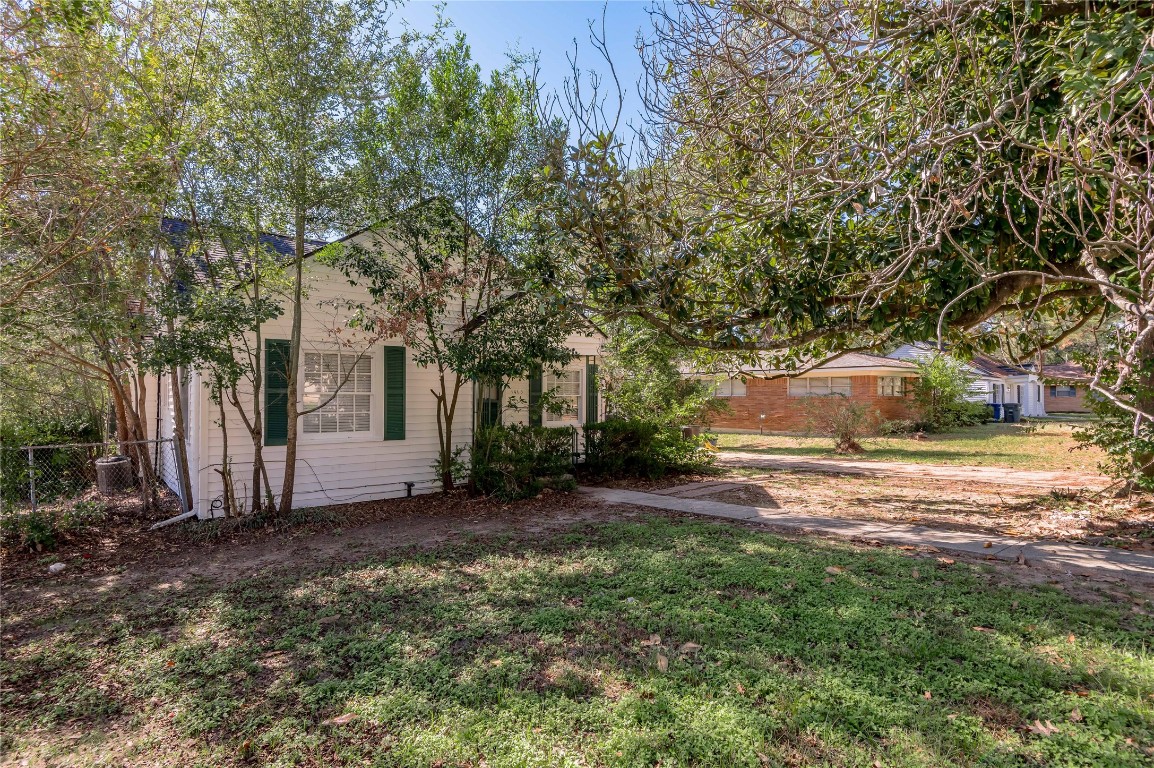1415 22nd Street Huntsville, TX 77340 - Photo 22 of 30 a view of a yard with plants and trees