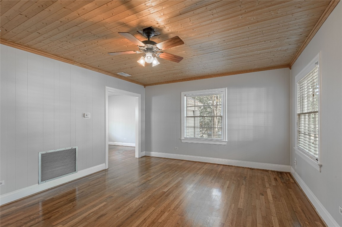 1415 22nd Street Huntsville, TX 77340 - Photo 4 of 30 a view of an empty room with wooden floor and a window