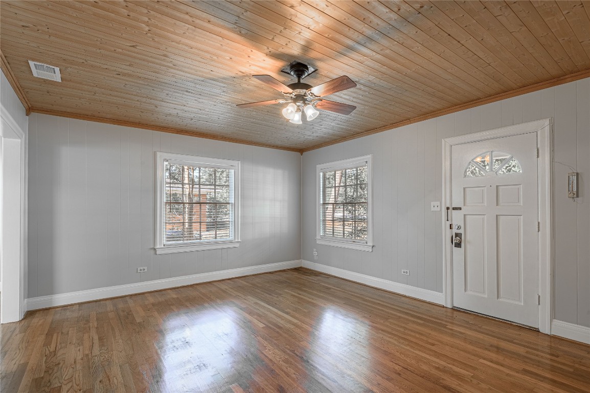 1415 22nd Street Huntsville, TX 77340 - Photo 5 of 30 a view of an empty room with a window and wooden floor