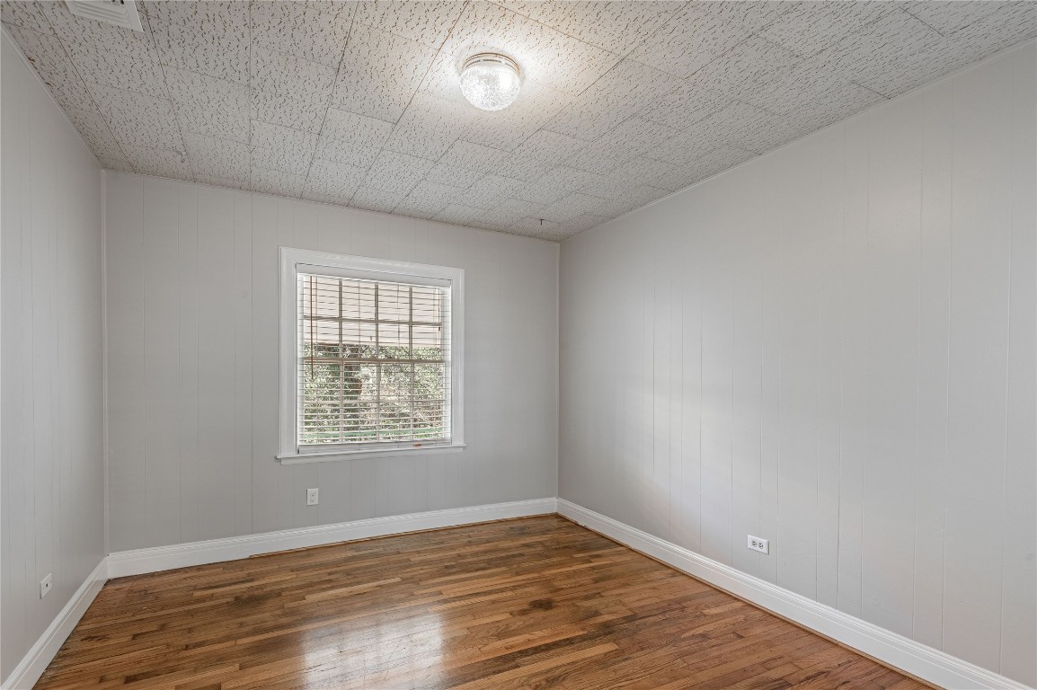 1415 22nd Street Huntsville, TX 77340 - Photo 7 of 30 an empty room with wooden floor and windows