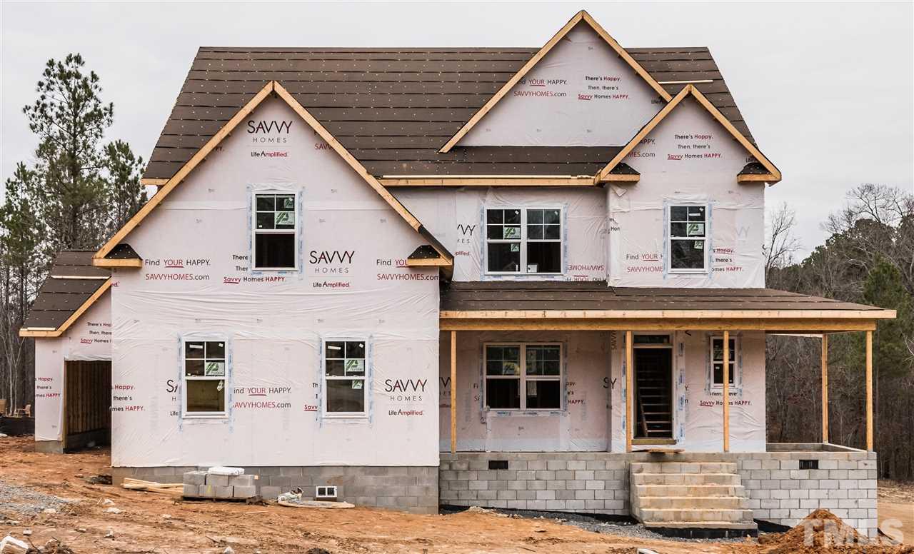 1117 Harrison Ridge Road Wake Forest, NC 27587 - Photo 1 of 6 a view of a white house with large windows