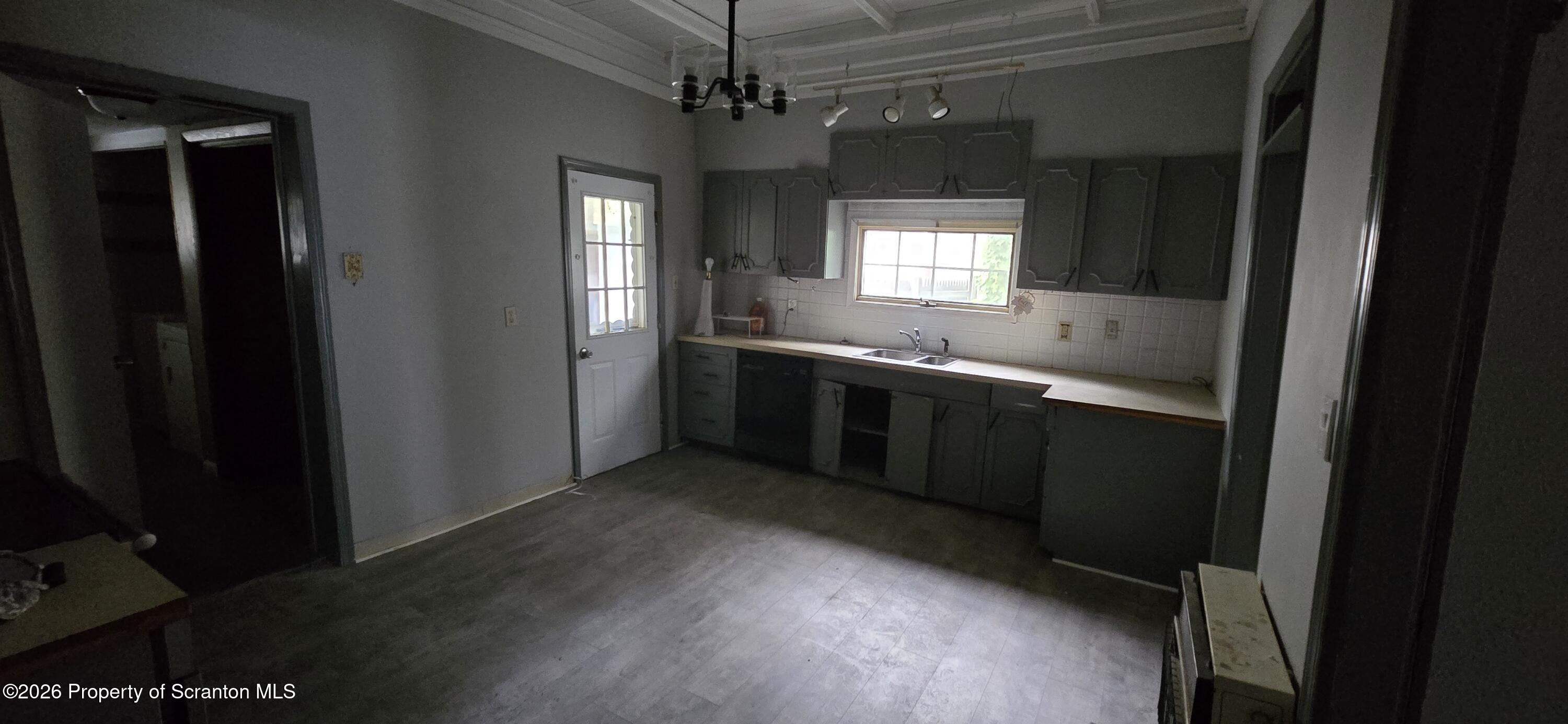 1140-1142 Academy Street Scranton, PA 18504 - Photo 13 of 49 a kitchen with a sink and chandelier