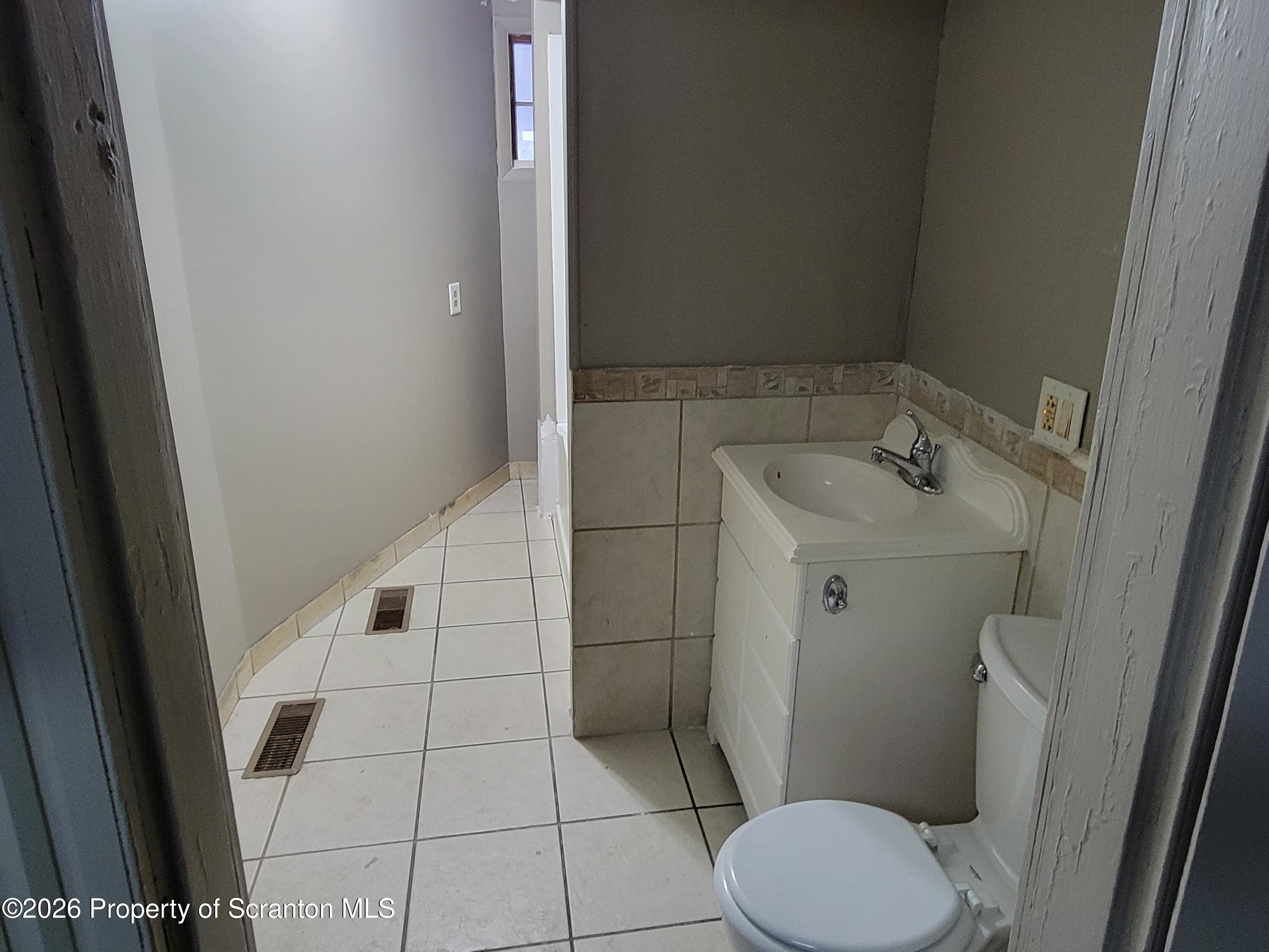 1140-1142 Academy Street Scranton, PA 18504 - Photo 32 of 49 a bathroom with a sink and toilet