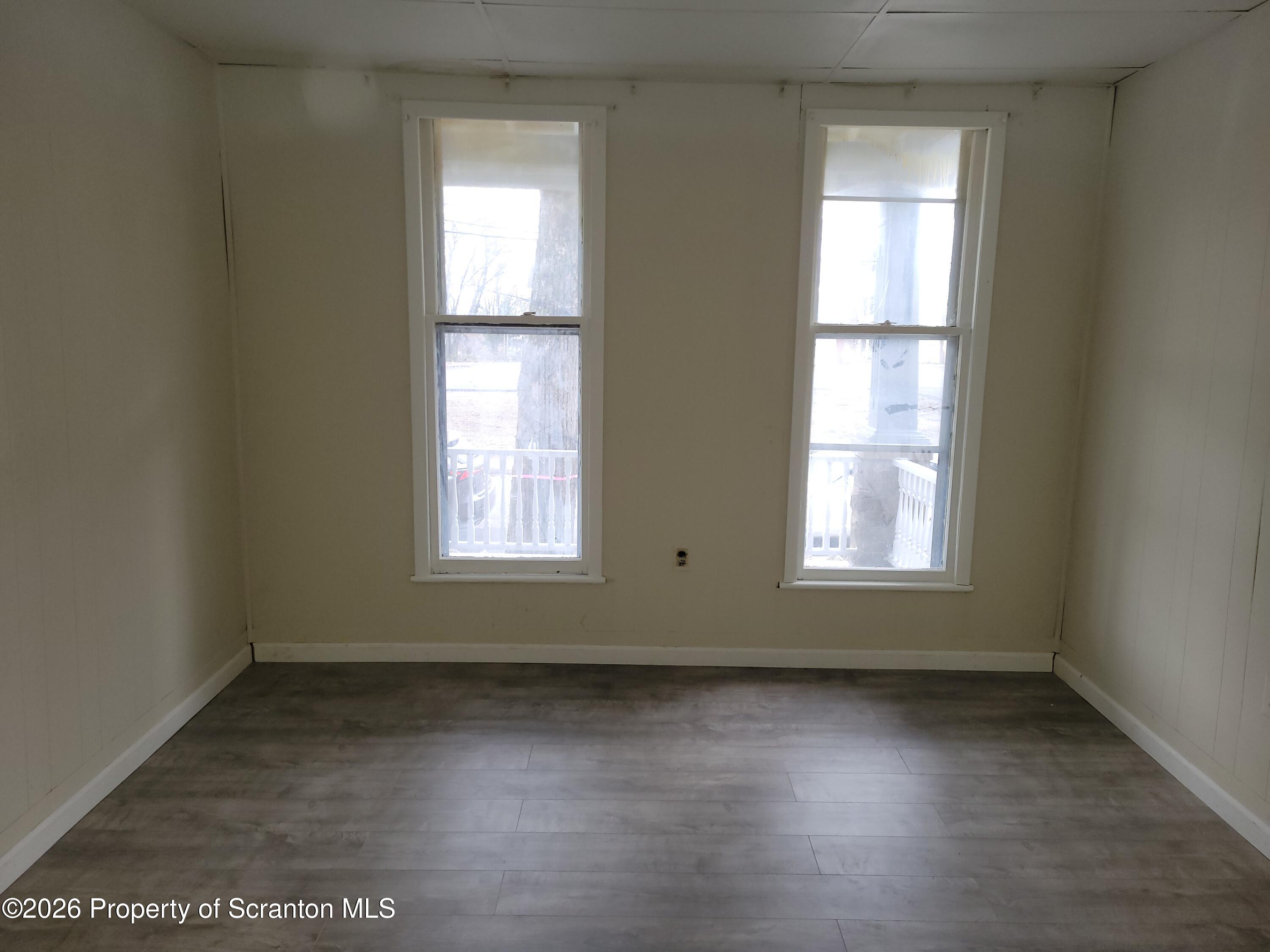1140-1142 Academy Street Scranton, PA 18504 - Photo 36 of 49 an empty room with wooden floor and windows