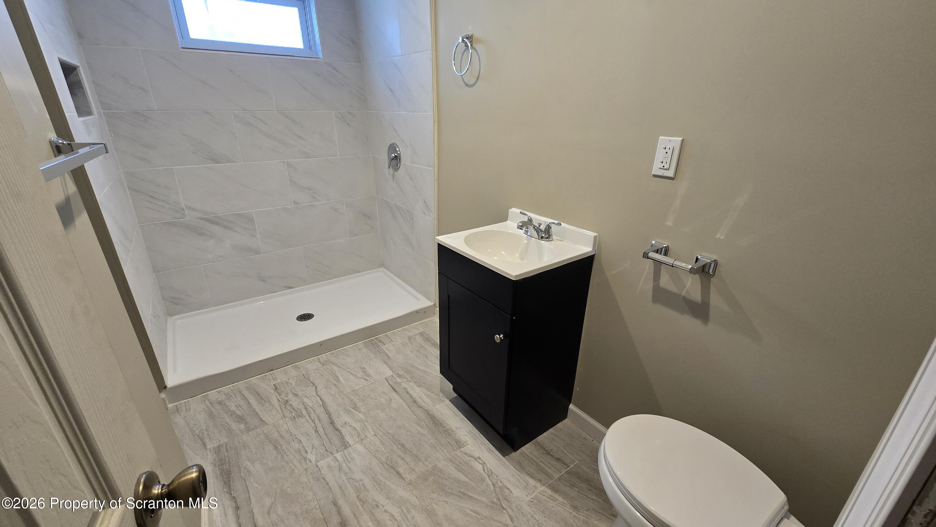 1140-1142 Academy Street Scranton, PA 18504 - Photo 42 of 49 a bathroom with a sink and a mirror