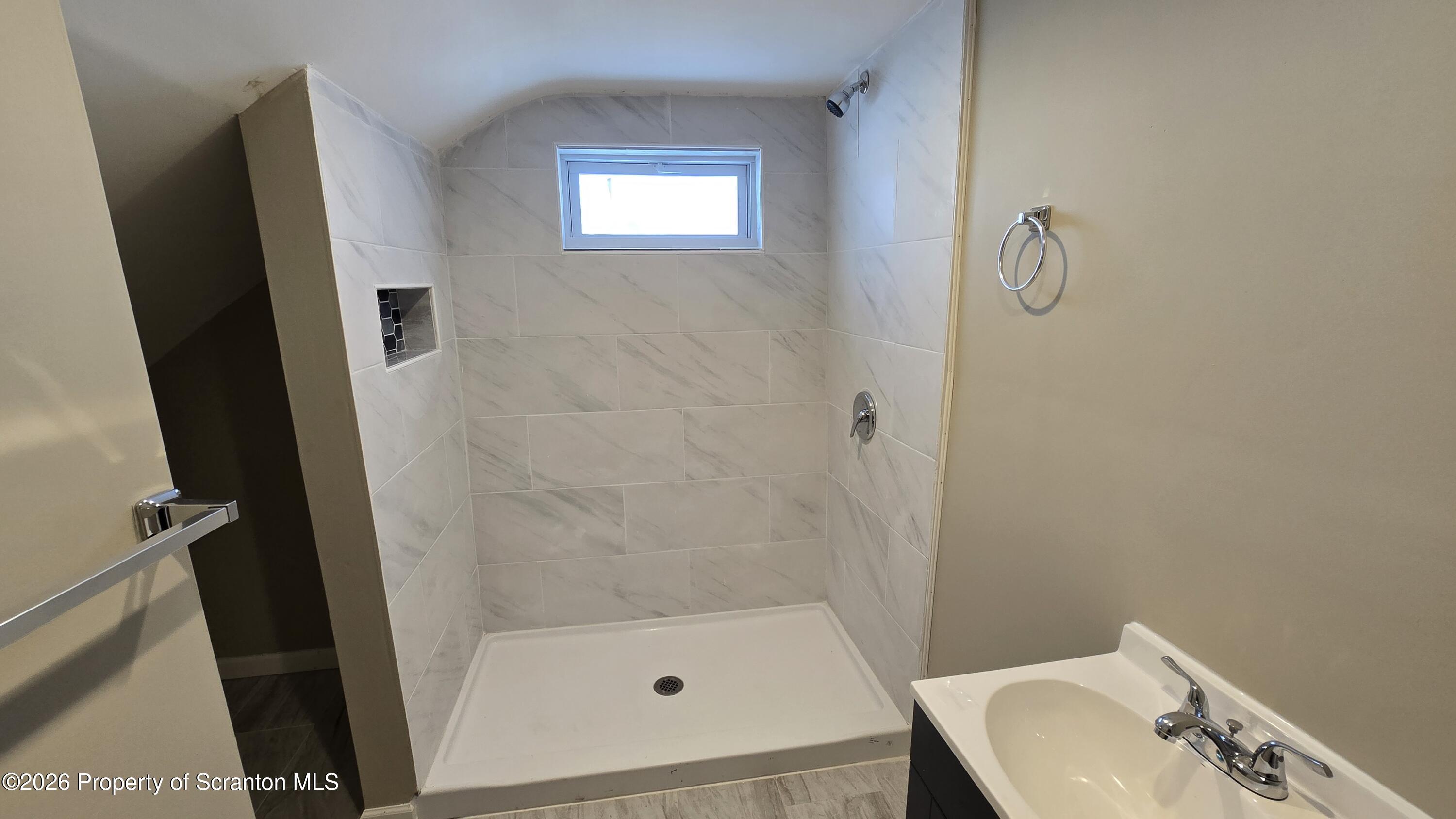 1140-1142 Academy Street Scranton, PA 18504 - Photo 43 of 49 a bathroom with a sink and a mirror