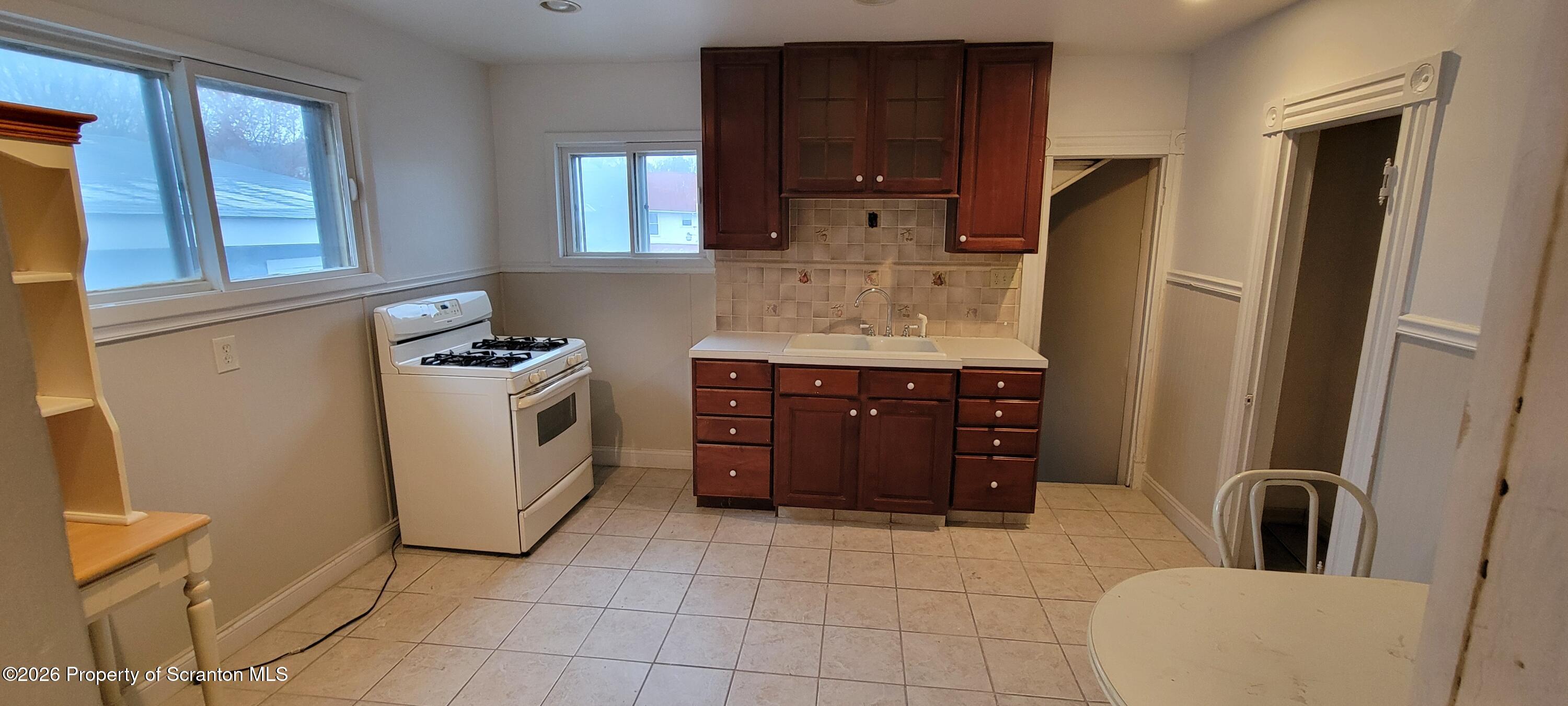 1140-1142 Academy Street Scranton, PA 18504 - Photo 47 of 49 a kitchen with a cabinets and appliances