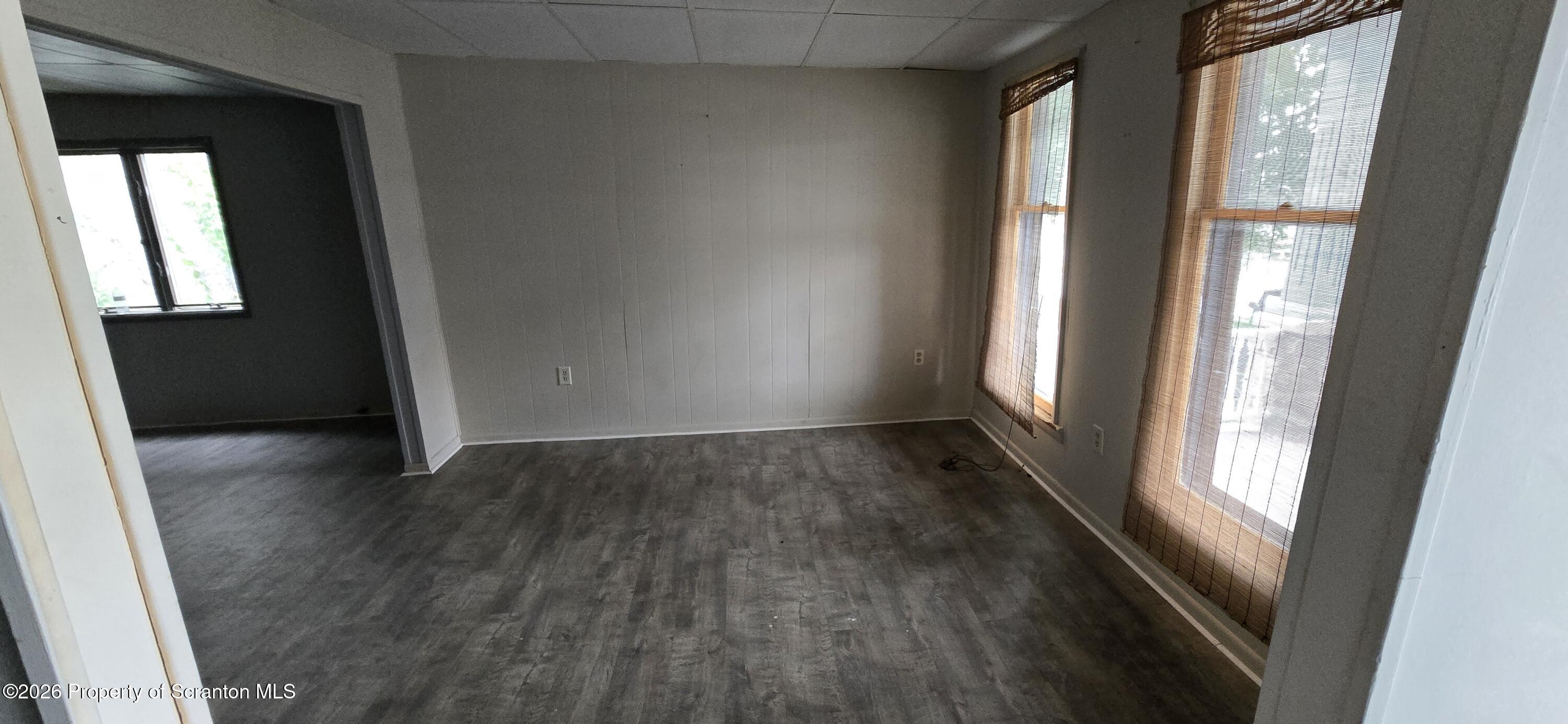 1140-1142 Academy Street Scranton, PA 18504 - Photo 6 of 49 an empty room with wooden floor and windows