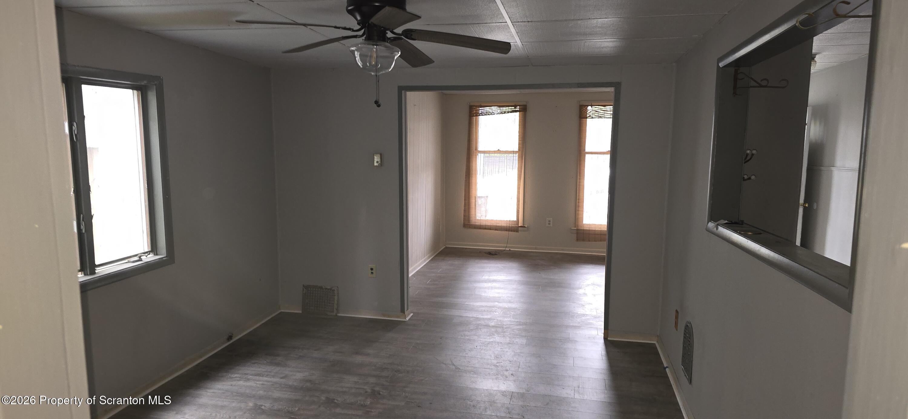 1140-1142 Academy Street Scranton, PA 18504 - Photo 9 of 49 a view of a hallway with wooden floor and windows