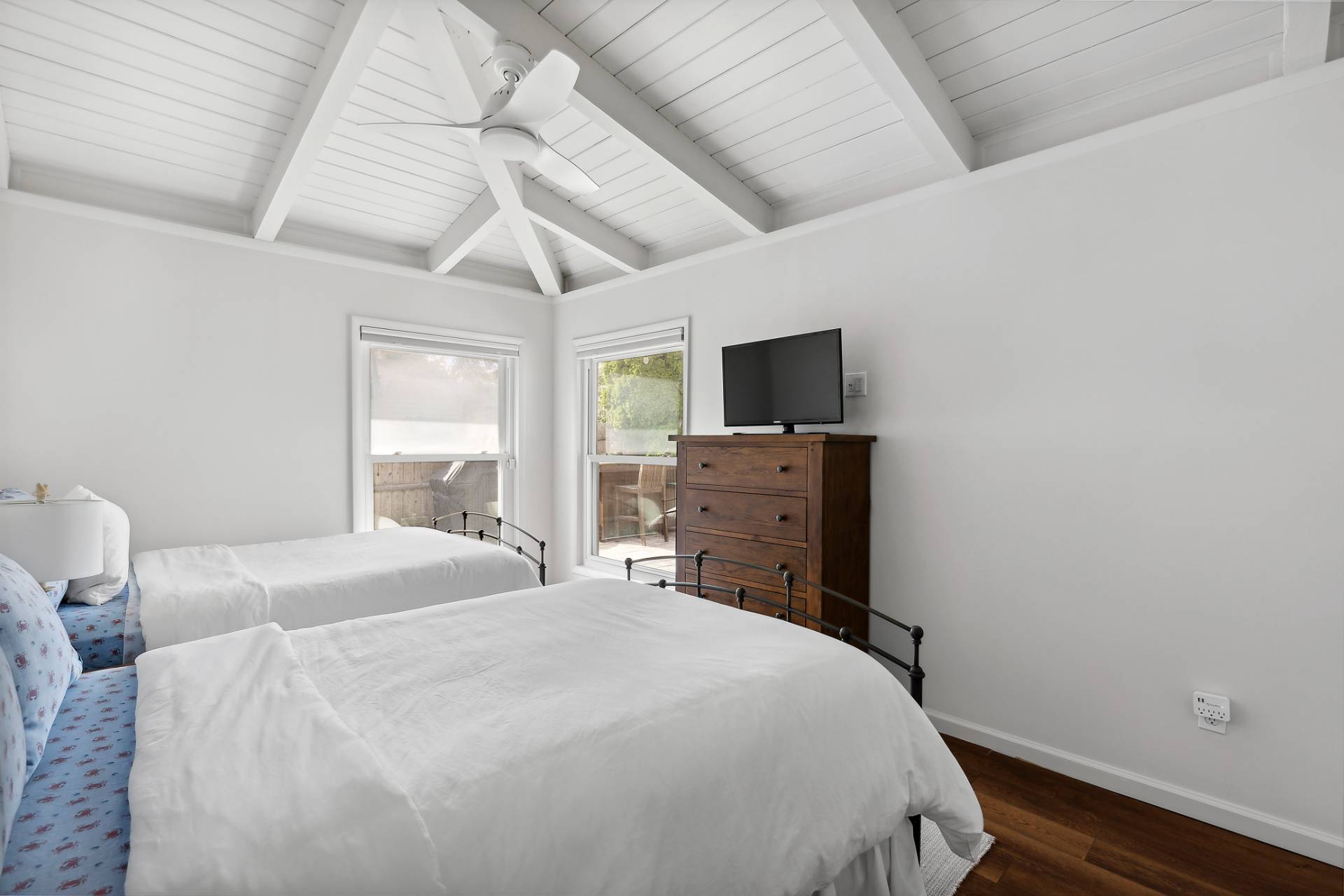 1 Shadbush Road Montauk, NY 11954 - Photo 14 of 19 a bedroom with a bed and a flat tv screen on dresser