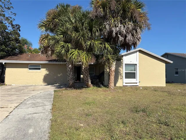 a view of a house with a yard and garage