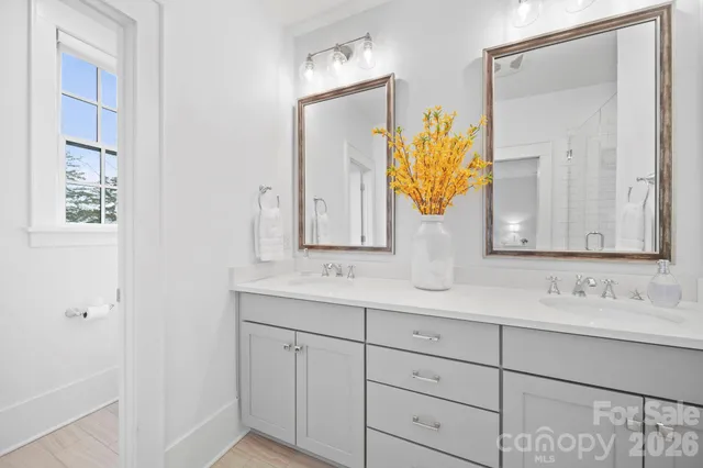 a bathroom with a double vanity sink and mirror
