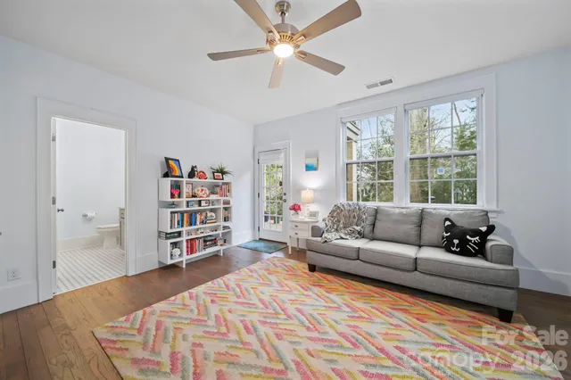 a living room with furniture and a book shelf