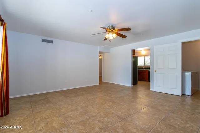 an empty room with closet and windows