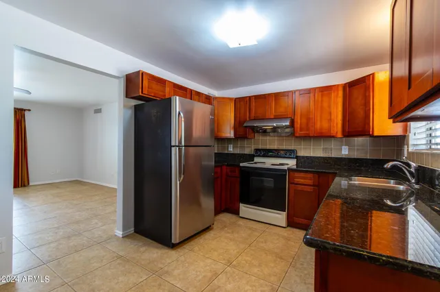a kitchen with a refrigerator and a sink
