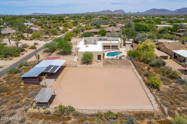 an aerial view of a house with a yard