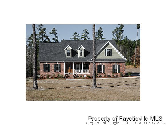 Lot 12 Booth Pond Road Raeford, NC 28376 - Photo 1 of 11 a view of a white house with a city view