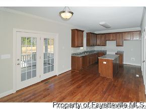 Lot 12 Booth Pond Road Raeford, NC 28376 - Photo 4 of 11 a room with kitchen island wooden floors and stainless steel appliances