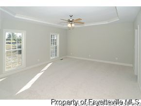 Lot 12 Booth Pond Road Raeford, NC 28376 - Photo 6 of 11 a view of a livingroom with a ceiling fan and window