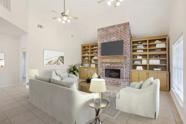 a living room with furniture a fireplace and a flat screen tv