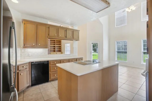 a kitchen with granite countertop a sink stove and cabinets